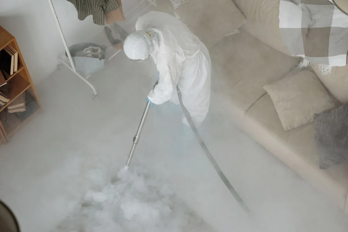 Biohazard cleanup technician in protective equipment, Huntsville, MO